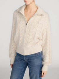 Side view of the FRAME Airy Lurex Quarter Zip sweater in Biscuit showing the sleeve and ribbed hem.