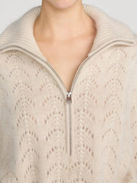 Close up of the quarter zip and ribbed collar on the FRAME Airy Lurex Quarter Zip sweater in Biscuit.