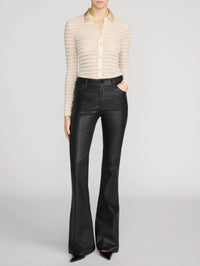 Full-length front view of the FRAME Bubble Stitch Shirt in Cream tucked into black leather flares