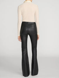 Back view of the FRAME Bubble Stitch Shirt in Cream worn with black leather flares