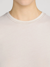 Close-up of contrast stitch neckline detail on the Contrast Stitch Baby Tee in Bone by FRAME