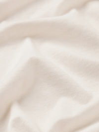 Close-up of textured knit fabric and contrast stitching detail on the Contrast Stitch Baby Tee in Bone by FRAME