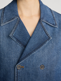 Close-up of double-breasted buttons and notch collar on the Denim Uniform Trench in Girlfriend by FRAME