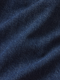 Close-up of indigo denim texture on the FRAME Denim Uniform Trench in Girlfriend wash