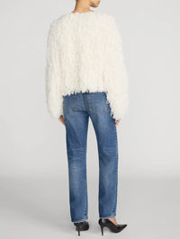 Back view on a model showing the rear pockets of the FRAME The Hang jean in Lucky.