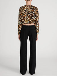 Back view of the FRAME Pleated Bubble Top in Abstract Leopard showing the keyhole closure