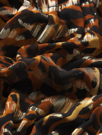 Fabric detail of the silk and lurex animal print on the FRAME Pleated Bubble Top in Abstract Leopard