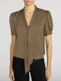 Front view of The Sonnet Blouse in Moss by FRAME, featuring puffed sleeves and a tie-front neckline