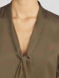 Close-up of the plunging neckline with tie detail on the Sonnet Blouse in Moss by FRAME