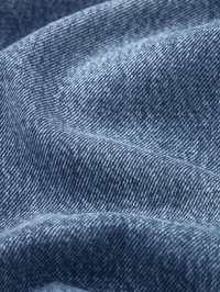 Close-up of the indigo twill weave texture and relaxed fit silhouette of the Swing Jean in Lucky Raw After by FRAME