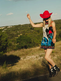 Model wearing the Fraulein Butterfly cowboy boot in black with a mini dress in the Texas Hill Country