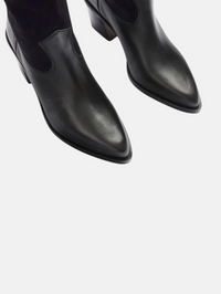 Close-up of the pointed-toe Nancie Boot in navy suede combo by FREDA SALVADOR, showing elastic side panels