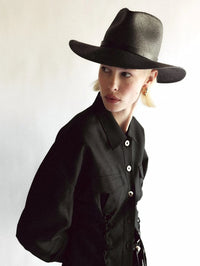 Front view of the Sherman Hat in black by Janessa Leone, worn with a black shirt