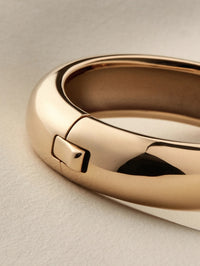 Close-up of the tab lock closure on the Jenny Bird Gemma Bangle in high polish gold.