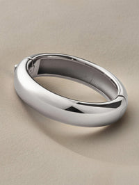 Angled view of the Jenny Bird Gemma Bangle in platinum on a soft neutral backdrop.