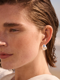 Close-up of the Nelle Hoops in High Polish Silver by Jenny Bird worn on model's ear