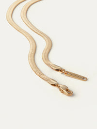 Detail of the lobster clasp and logo tag on the Jenny Bird Zeina Chain in gold.