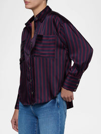 Side view of the L'AGENCE Eliora Relaxed Blouse showing the dropped shoulder and buttoned cuff in midnight sangria stripe.