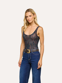 Three quarter view of the L'AGENCE Kalea Mesh Bodysuit in Midnight Multi Lux Paisley with a belted wide leg jean.