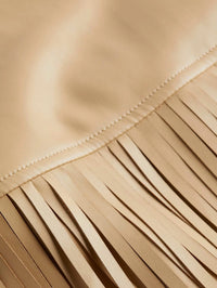 Close-up of the stitched seam and fringe on the L'AGENCE Karolina Fringe Skirt in Croissant.