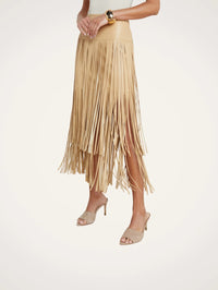 Side angle of the L'AGENCE Karolina Fringe Skirt in Croissant with fringe in motion.