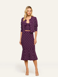 Full-length view of the L'AGENCE Kota Jacquard Cardigan in Dark Plum/Ivory Polka Dot styled with a matching skirt