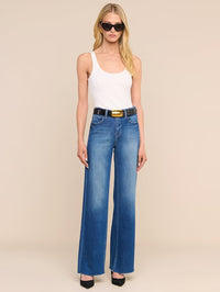 Front view of the Nica Tank Bodysuit in white by L'AGENCE, styled with blue jeans and belt
