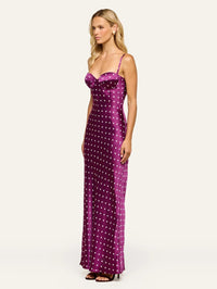 Side view of the L'AGENCE Sayla silk maxi dress in Dark Plum/Ivory Polka Dot showing the long drape