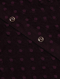 Close-up of the Swiss dot fabric and gold buttons on the L'AGENCE Sophie Blouse in Deep Sangria