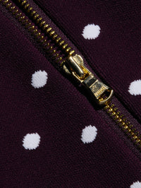 Close-up of the gold back zip and jacquard dots on the L'AGENCE Tula Knit Bra Top in Dark Plum/Ivory Polka Dot