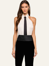 Front view of the L'AGENCE Wren Neck-Tie Top in White/Black styled with a black cummerbund and velvet trousers