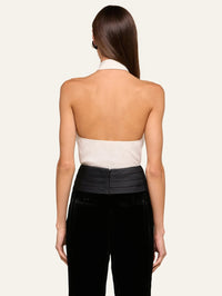 Back view of the L'AGENCE Wren Neck-Tie Top in White/Black showing the open halter back, tucked