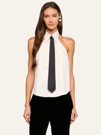 Front view of the L'AGENCE Wren Neck-Tie Top in White/Black worn untucked showing the curved hem