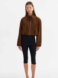 Full-length front view of the LAMARQUE Anita Suede Bomber Jacket in Brown worn with black cropped pants.