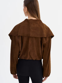 Back view of the LAMARQUE Anita Suede Bomber Jacket in Brown with the wide collar draped over the shoulders.