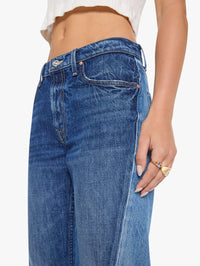 Close-up of the front waist and twisted seam on the MOTHER Bookie Slit Twist Heel Fray Jean in Double Take