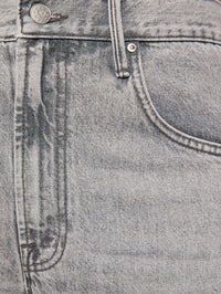 Detail of the pretzel button and fading on MOTHER Lemon Twist Sneak jeans in Rocky Road denim.