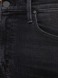 Fabric detail of the faded black stretch denim on the MOTHER Newbie Skimp Jean in Bootleg