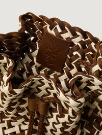 Interior view of the NAGHEDI Gramercy Bucket Double Weave in Carmel with its embossed logo patch.