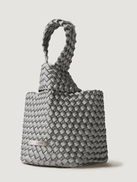 Side angle of the NAGHEDI Kyoto Clutch Satin in Graphite showing the woven loop and logo plate.