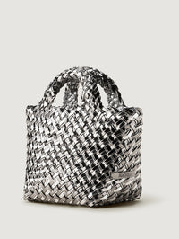 Side angle of the NAGHEDI St. Barths Petit Tote in Pewter showing the metallic weave and logo tab.