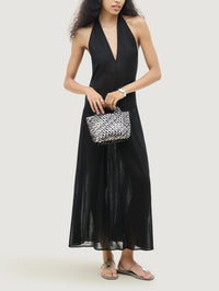 Model carrying the NAGHEDI St. Barths Petit Tote in Pewter with a black halter maxi dress.