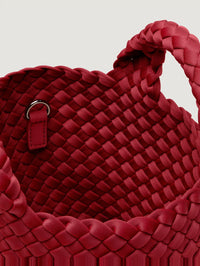 Interior view of the NAGHEDI St. Barths Petit Tote in Rosso showing the red handwoven neoprene and strap ring.