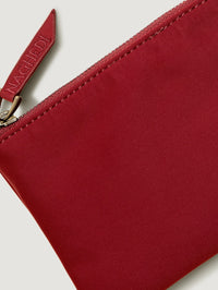 Detail of the red zippered pouch included with the NAGHEDI St. Barths Petit Tote in Rosso.