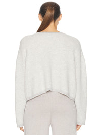 Back view of the Charlene C Jacket in Foggy Gardenia by SABLYN, showing cropped ribbed knit silhouette