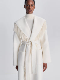 Close front view of the fringed shawl collar on the SIMKHAI Carrie Fringe Coat in Frost.