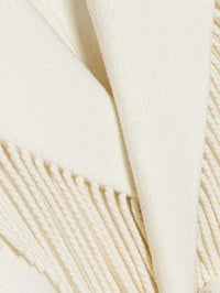 Close-up of the wool fabric and twisted fringe on the SIMKHAI Carrie Fringe Coat in Frost.