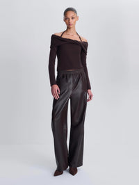 Full length front view of a model in the SIMKHAI Corrine Leather Pant in Dark Chocolate