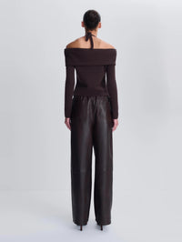 Back view of the SIMKHAI Corrine Leather Pant in Dark Chocolate showing patch pockets