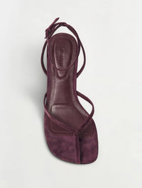 Top view of the SIMKHAI Kelsey Suede Strappy Wedge in fig showing slim suede straps and leather footbed.